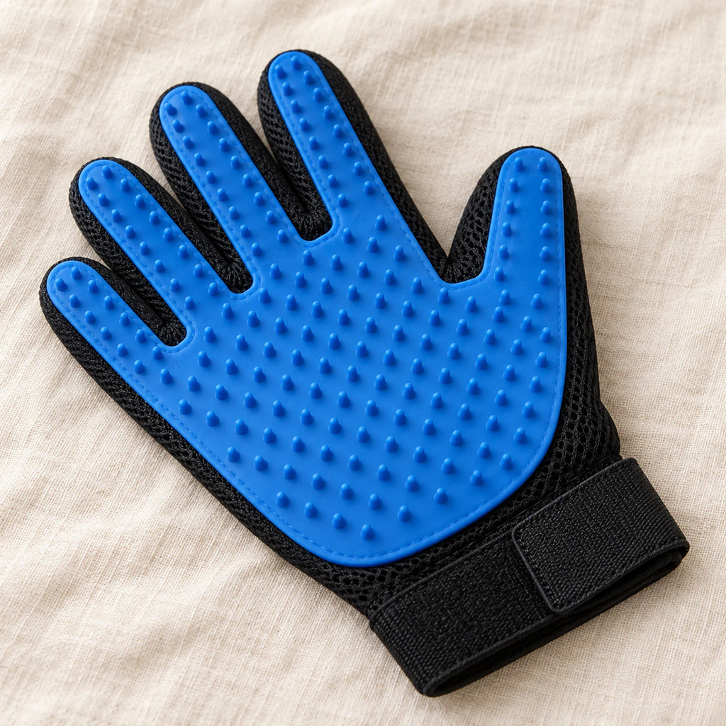 Blue silicone pet grooming glove with a black mesh back on a beige linen surface